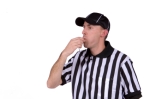 Football referee blowing whistle